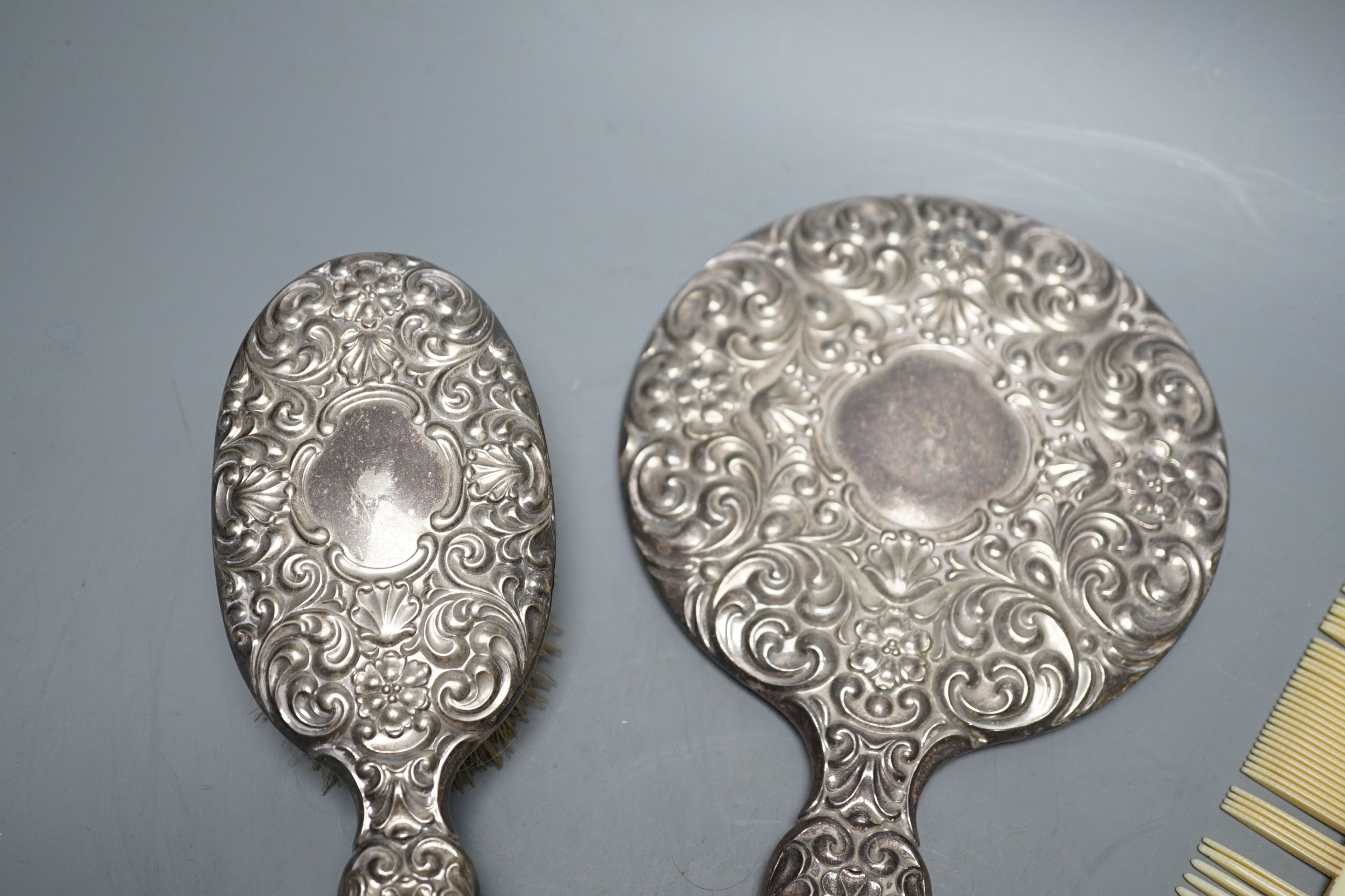 A continental 800 standard white metal mounted four piece mirror and brush set.